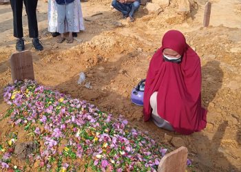 Keluarga mengunjungi makam Hartijo (49), seorang warga Batam, Kepulauan Riau, di TPU Temiang, yang meninggal usai menerima vaksin Covid-19 dua dosis sekaligus. (Foto: Fathur Rohim)