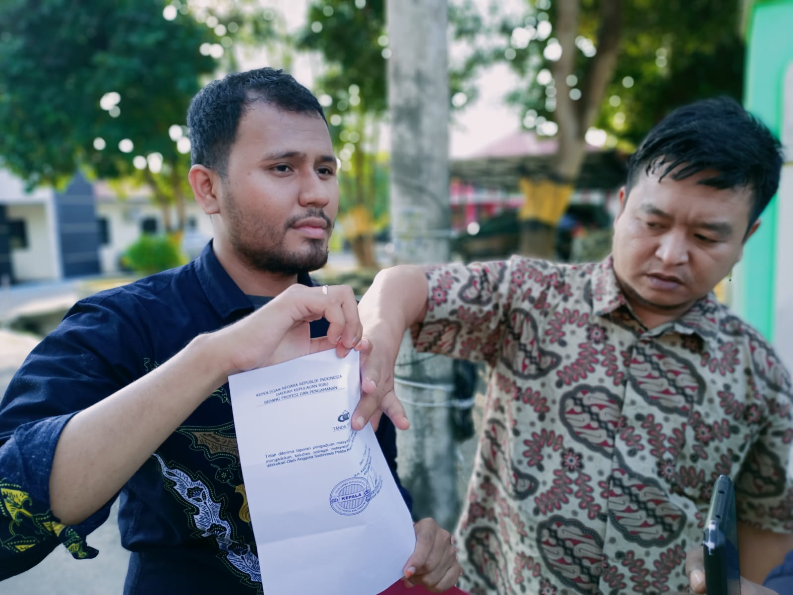 Abi (kanan) didampingi kuasa hukumnya, usai melapor ke Propam Polda Kepri, atas tindak intimidasi mantan wali murid, Rabu (18/01/2023). (Foto: Istimewa).