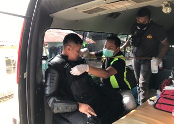 Seorang personel Brimob Polda Kepri, Toto Harianto mendapatkan perawatan medis setelah bahu kirinya terkena anak panah saat kericuhan di kawasan Tangki Seribu, Kelurahan Seraya, Kecamatan Batu Ampar. (Foto: Irvan Fanani)